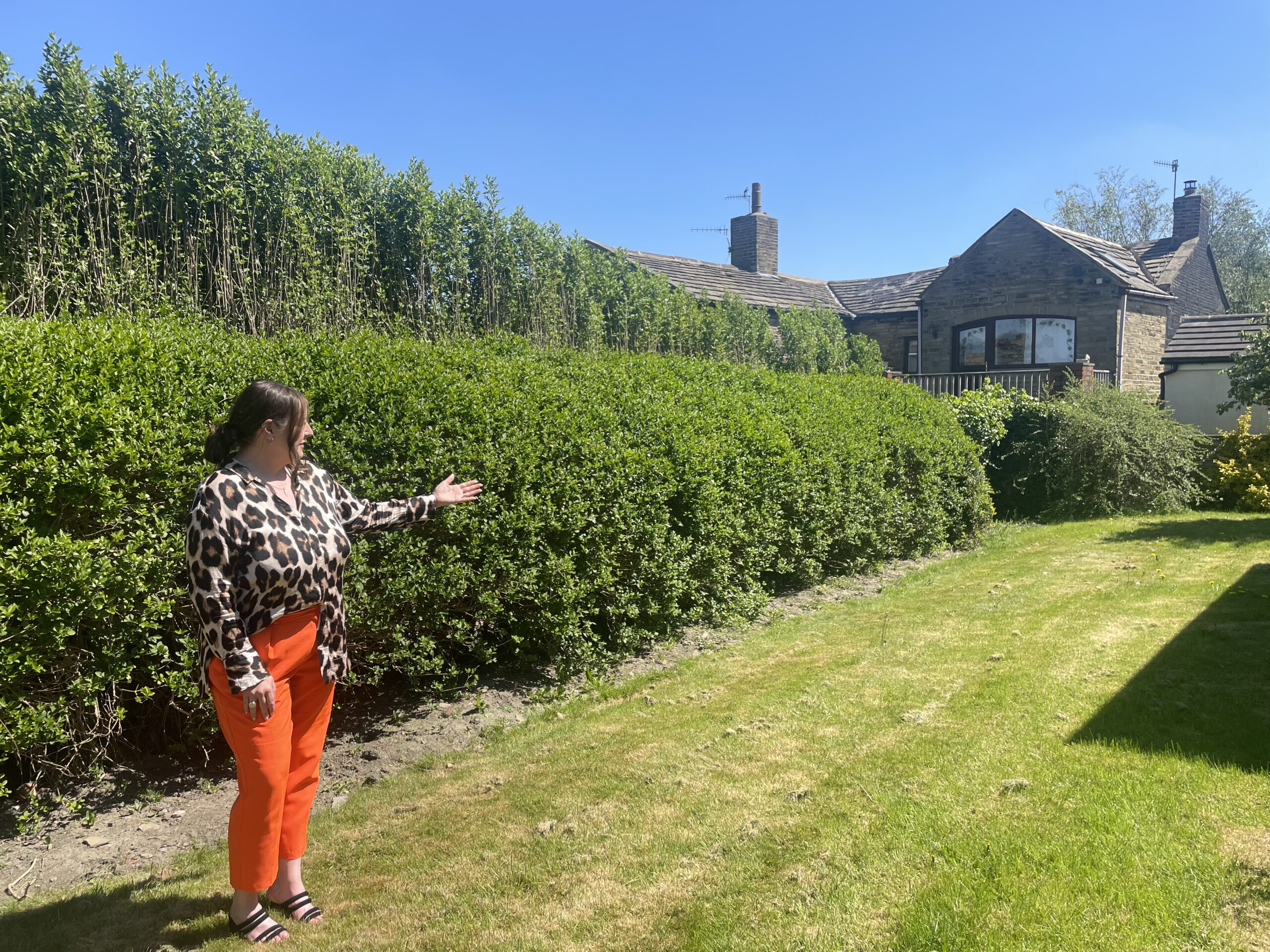 Patchett Homes Senior Lettings Manager showing a large garden on a sunny day.